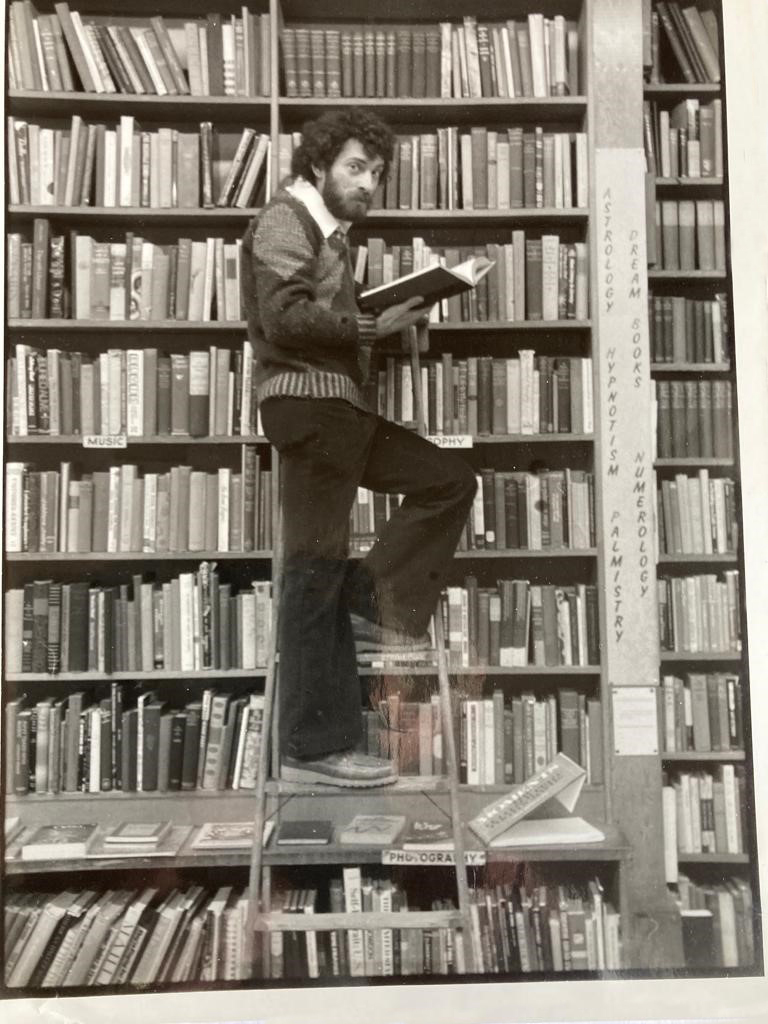 Man on ladder in book shop